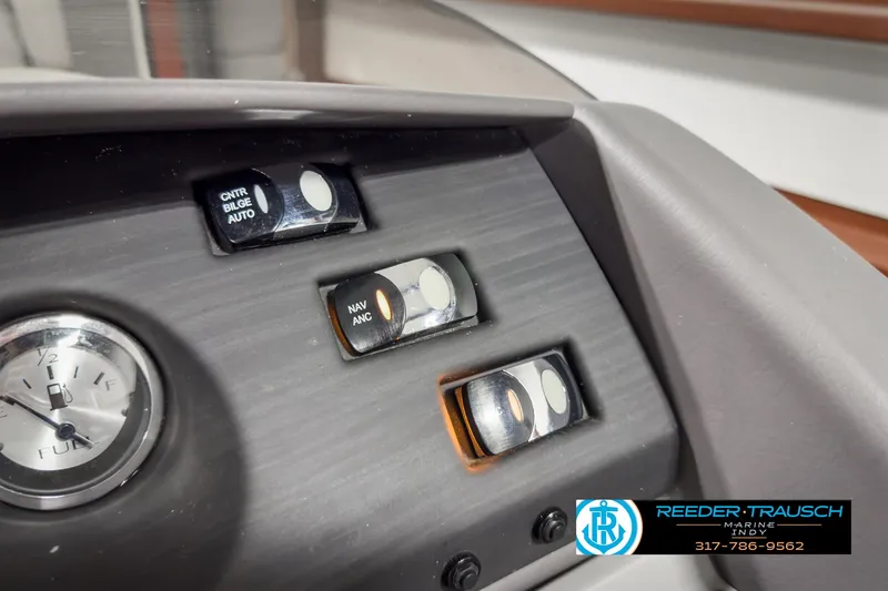 Slide: The Image of Dashboard controls of 2022 Bennington 23 LSR boat with clock and switches. - 31