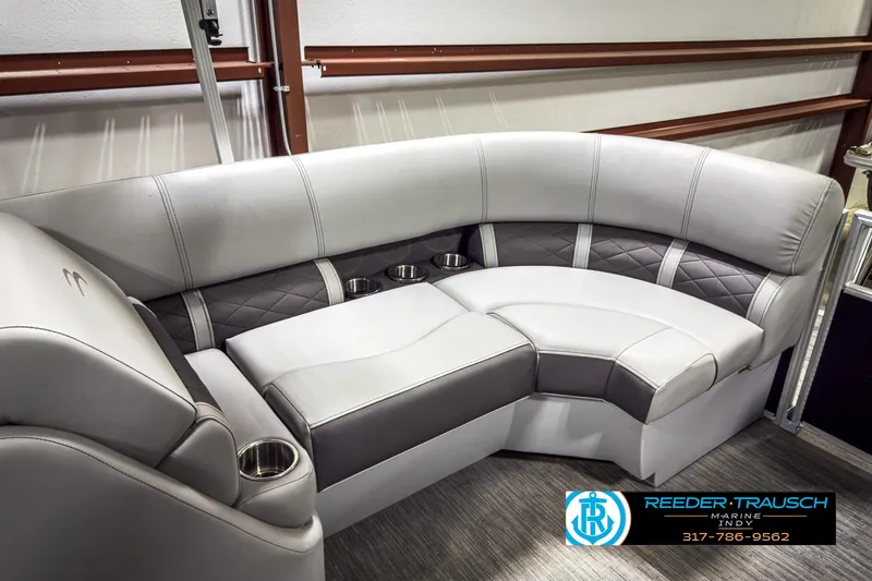 Slide: The Image of 2022 Bennington 23 LSR boat interior with plush seating and cup holders. - 35