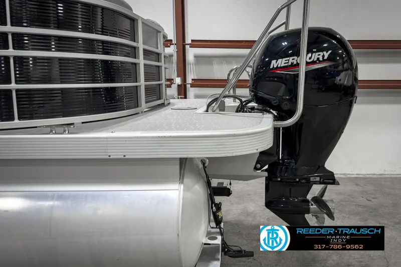 Slide: The Image of 2022 Bennington 23 LSR pontoon boat with Mercury outboard motor in showroom. - 40