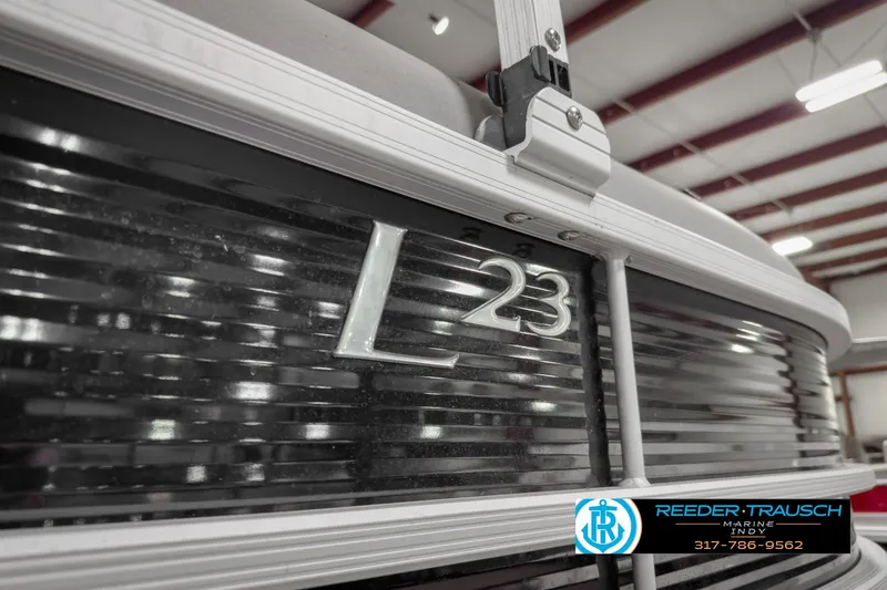 Slide: The Image of 2022 Bennington 23 LSR boat detail in showroom with logo. - 46