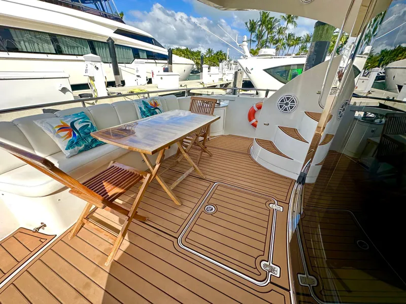 Slide: The Image of Luxurious 2007 Marquis 59 Markham Edition yacht deck with seating and table. - 10
