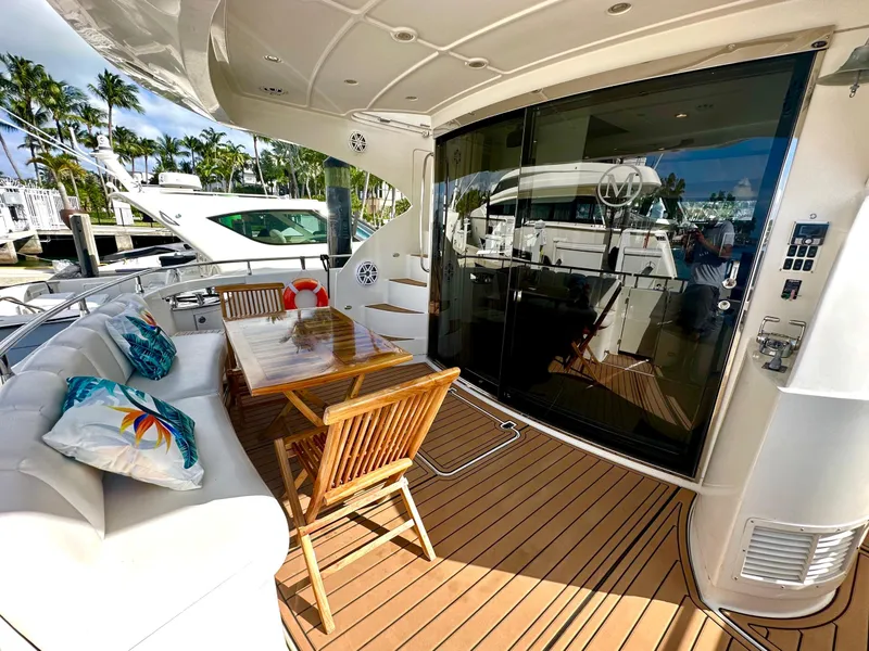 Slide: The Image of Luxurious 2007 Marquis 59 Markham Edition yacht deck with seating and dining area. - 11