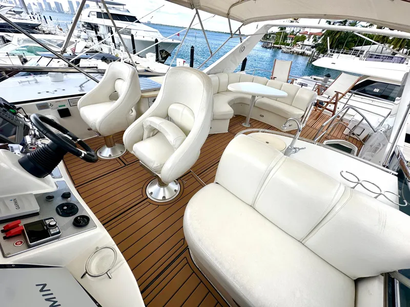 Slide: The Image of Luxurious 2007 Marquis 59 Markham Edition yacht interior with white leather seating and wood flooring. - 19