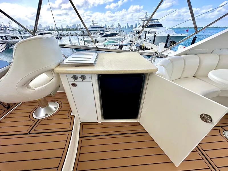 Slide: The Image of Luxurious 2007 Marquis 59 Markham Edition yacht interior with seating and open cabinet. - 21