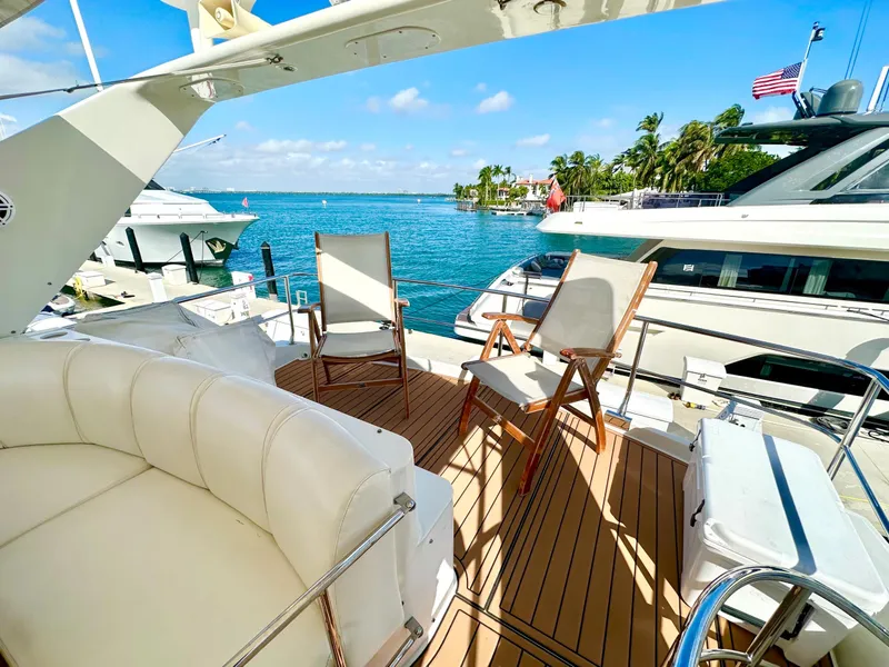 Slide: The Image of Luxurious 2007 Marquis 59 Markham Edition yacht deck with seating, overlooking marina and ocean. - 22