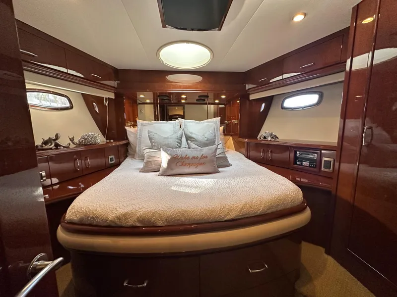 Slide: The Image of Luxurious 2007 Marquis 59 Markham Edition yacht bedroom with elegant wood finish and plush bedding. - 37