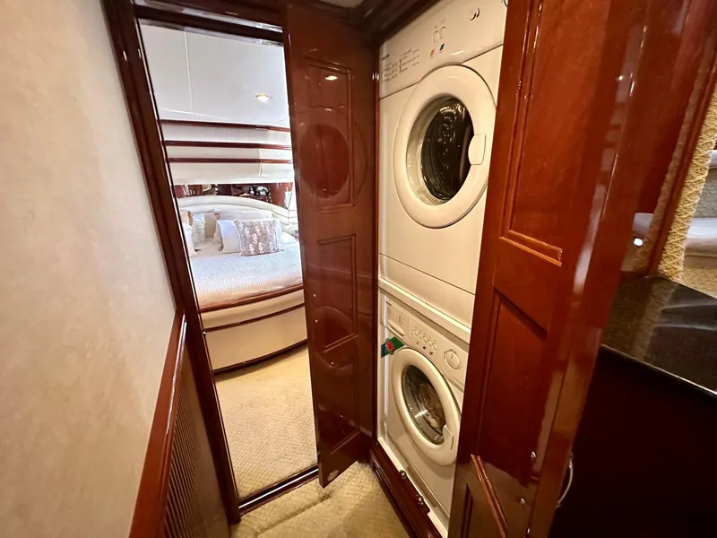 Slide: The Image of Laundry area in 2007 Marquis 59 Markham Edition yacht, featuring stacked washer and dryer. - 40
