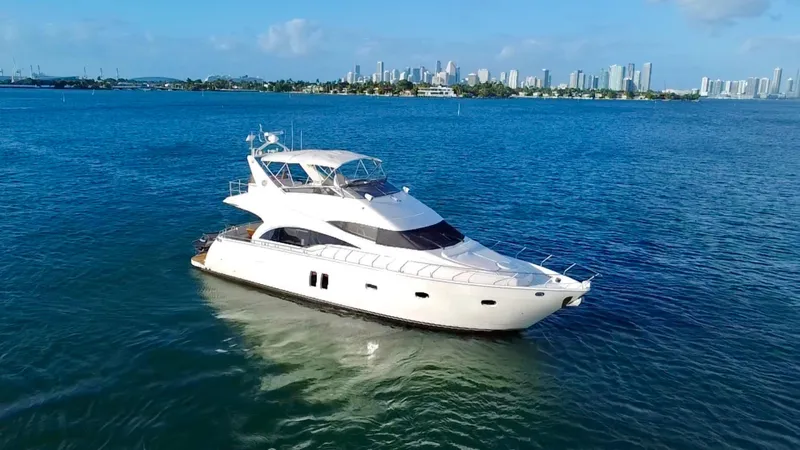 Slide: The Image of Luxurious 2007 Marquis 59 Markham Edition yacht cruising on blue waters near city skyline. - 6