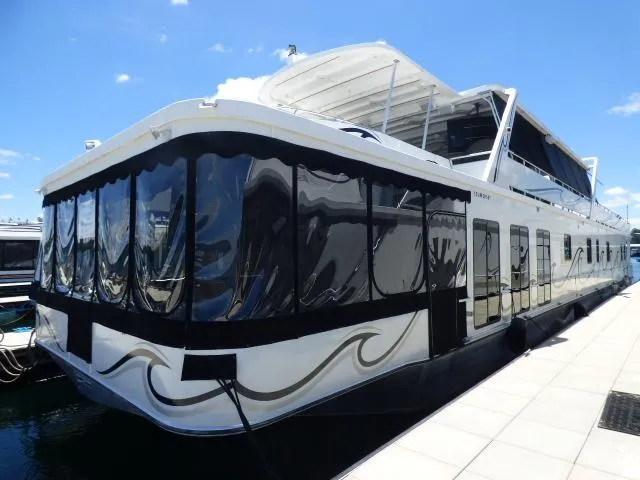 The Image of 2009 Sumerset 19x105 houseboat docked under clear blue sky. - 0