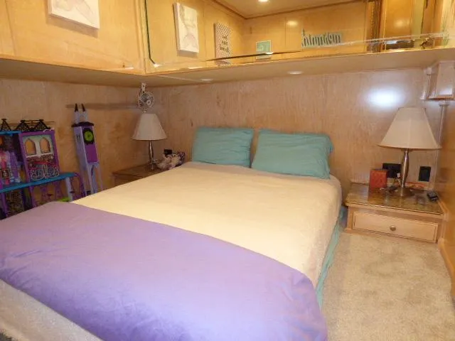 Slide: The Image of Cozy bedroom in 2009 Sumerset 19x105 houseboat with wooden decor and soft lighting. - 10