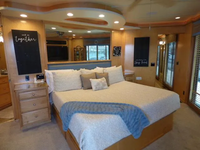 Slide: The Image of Luxurious bedroom interior in a 2009 Sumerset 19x105 houseboat, featuring a cozy bed and elegant decor. - 12