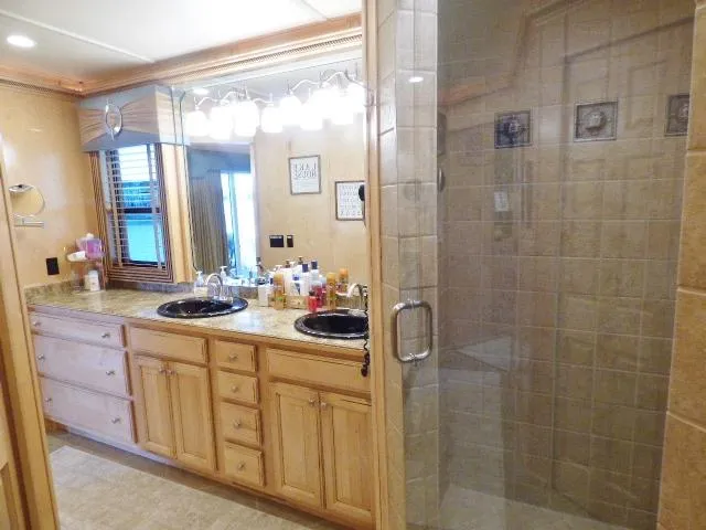 Slide: The Image of Luxurious bathroom in 2009 Sumerset 19x105 houseboat with dual sinks and glass shower. - 13