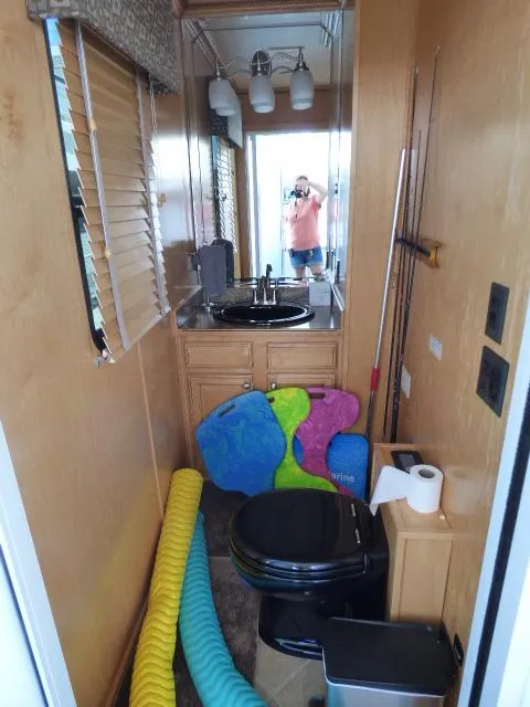 Slide: The Image of 2009 Sumerset 19x105 houseboat bathroom with sink, toilet, and colorful pool floats. - 15