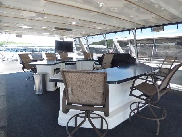 Slide: The Image of Luxurious 2009 Sumerset 19x105 houseboat interior with bar seating and modern amenities. - 17