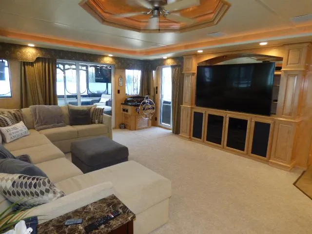Slide: The Image of Luxurious 2009 Sumerset 19x105 houseboat interior with spacious living area and large TV. - 3