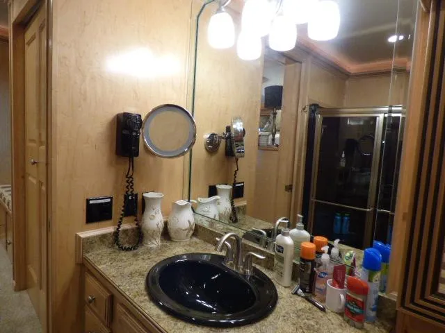 Slide: The Image of Luxurious bathroom in 2009 Sumerset 19x105 houseboat with granite countertop and modern fixtures. - 8