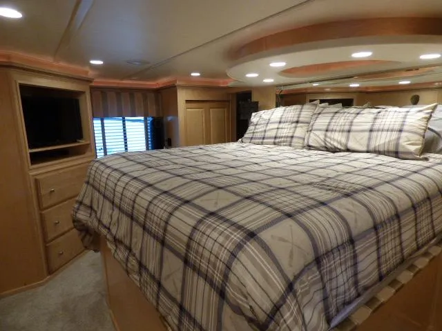Slide: The Image of Luxurious bedroom interior of 2009 Sumerset 19x105 houseboat with plaid bedding and modern lighting. - 9