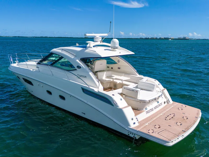 Slide: The Image of 2011 Sea Ray 470 Sundancer yacht on open water, featuring sleek design and spacious deck. - 10