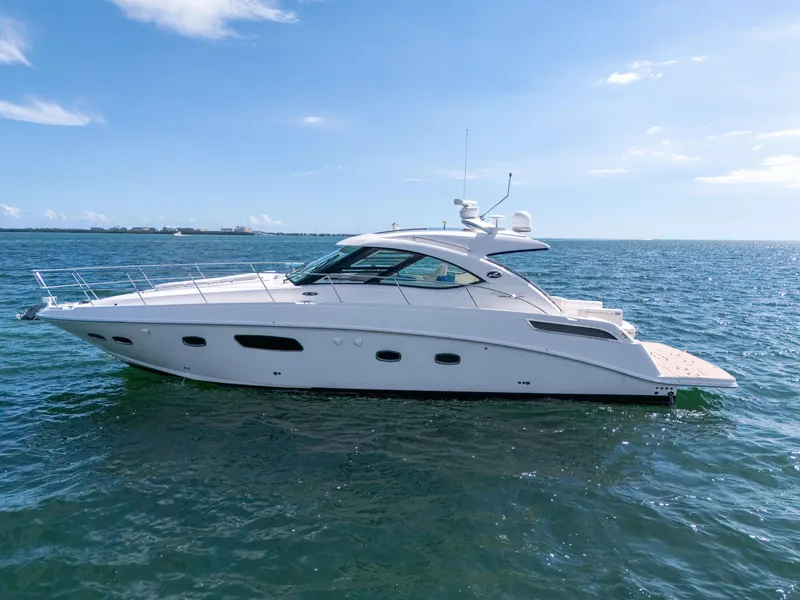 Slide: The Image of 2011 Sea Ray 470 Sundancer yacht cruising on open water under clear skies. - 11