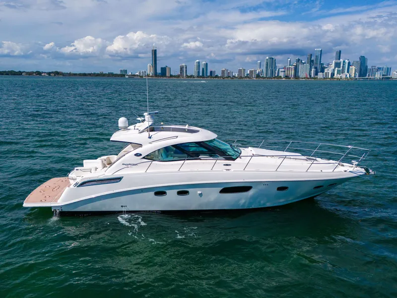 Slide: The Image of 2011 Sea Ray 470 Sundancer yacht cruising near city skyline. - 16