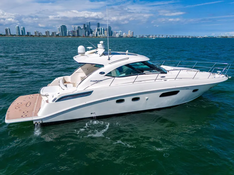 Slide: The Image of 2011 Sea Ray 470 Sundancer yacht cruising near city skyline on a sunny day. - 17