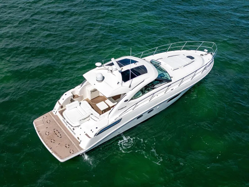 Slide: The Image of 2011 Sea Ray 470 Sundancer yacht cruising on open water. - 19