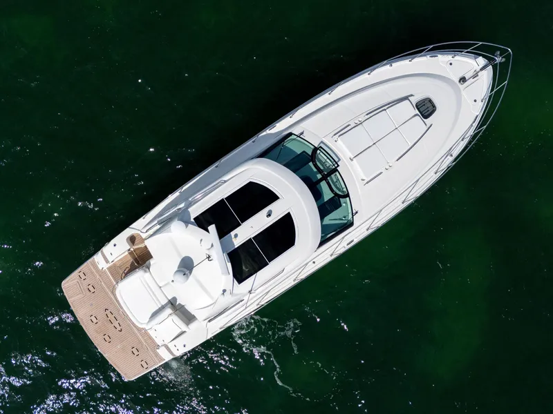 Slide: The Image of Overhead view of 2011 Sea Ray 470 Sundancer yacht on green water. - 20