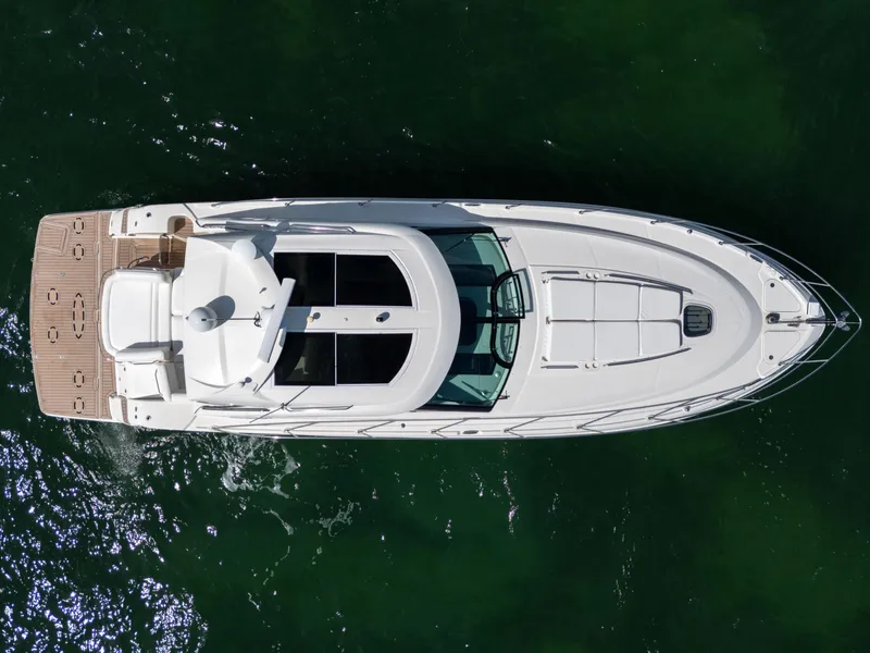 Slide: The Image of Overhead view of 2011 Sea Ray 470 Sundancer yacht on green water. - 21