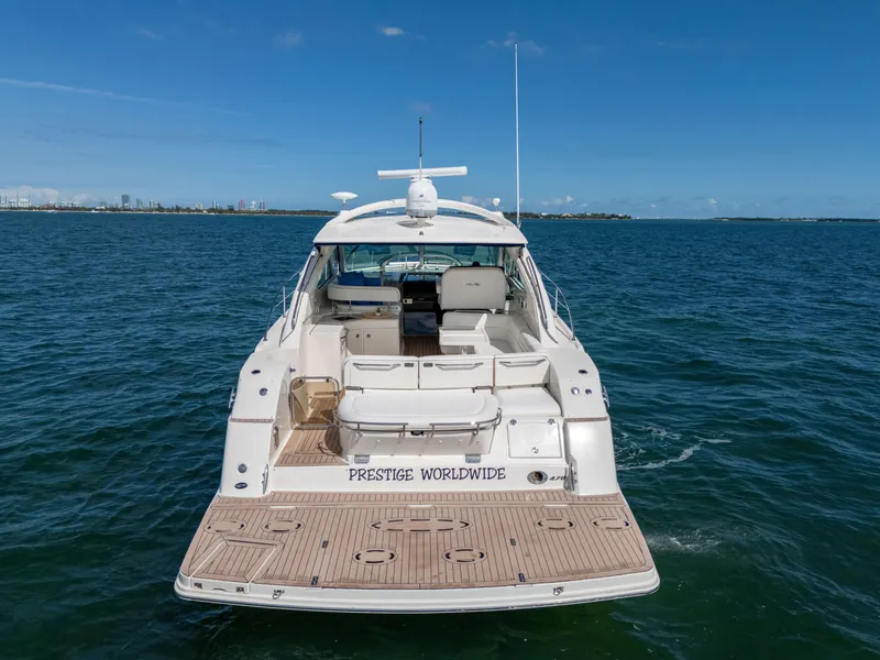 Slide: The Image of 2011 Sea Ray 470 Sundancer yacht on open water, rear view. - 25