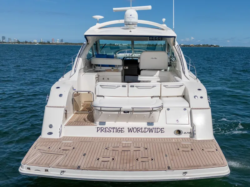 Slide: The Image of 2011 Sea Ray 470 Sundancer yacht on water, rear view, labeled "Prestige Worldwide." - 26