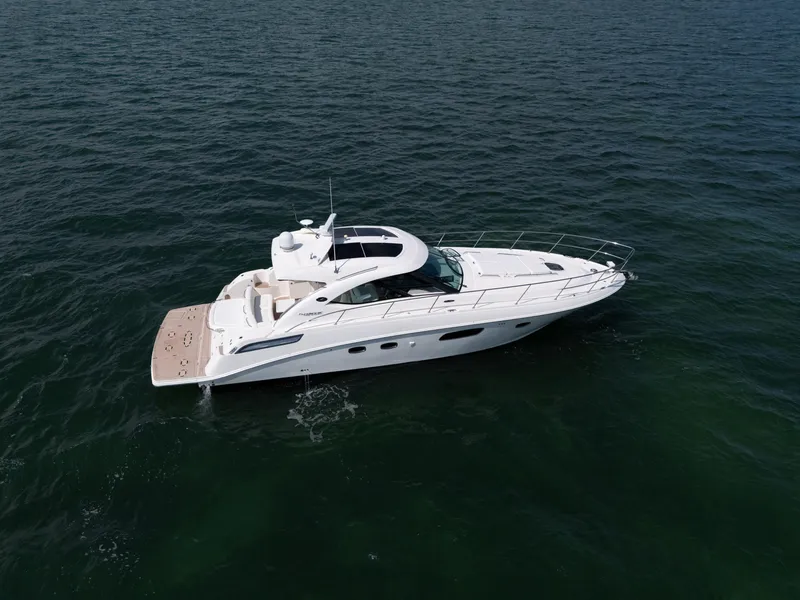 Slide: The Image of 2011 Sea Ray 470 Sundancer yacht cruising on open water. - 28