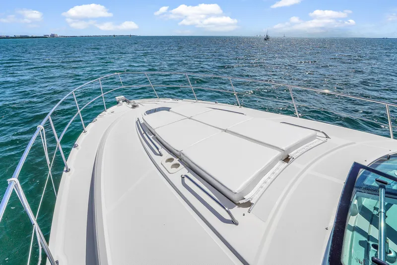 Slide: The Image of 2011 Sea Ray 470 Sundancer yacht on open water, showcasing sleek deck design. - 29