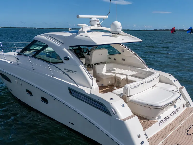 Slide: The Image of 2011 Sea Ray 470 Sundancer yacht on open water, featuring sleek design and spacious deck. - 31