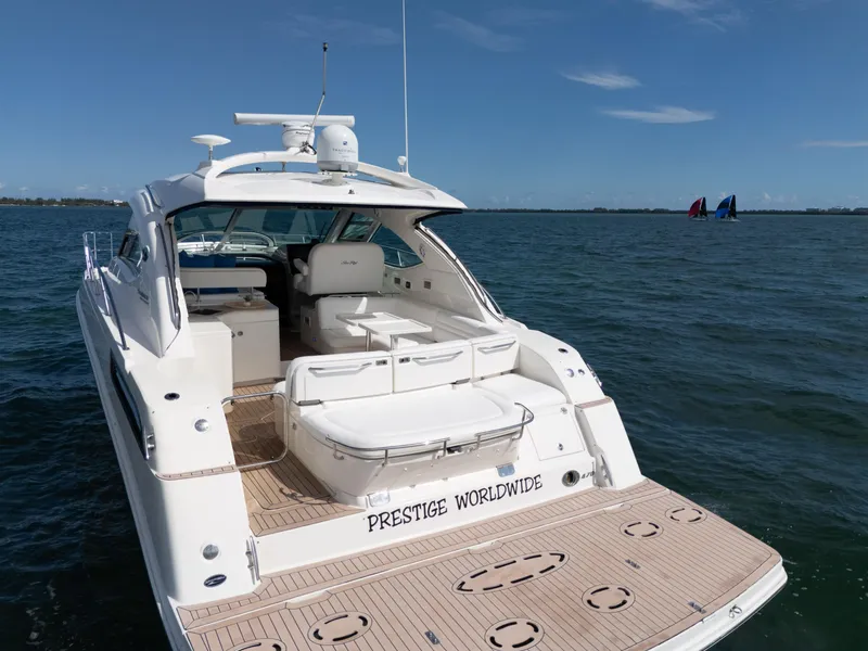 Slide: The Image of 2011 Sea Ray 470 Sundancer yacht on open water, featuring spacious deck and seating. - 33