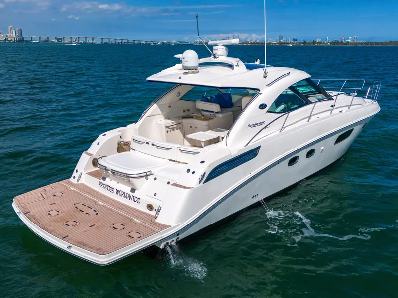 Slide: The Image of 2011 Sea Ray 470 Sundancer yacht cruising on open water, showcasing sleek design and luxury features. - 38