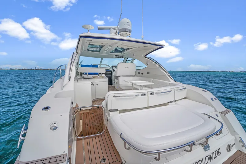 Slide: The Image of 2011 Sea Ray 470 Sundancer yacht on open water, featuring spacious deck and luxurious seating. - 39