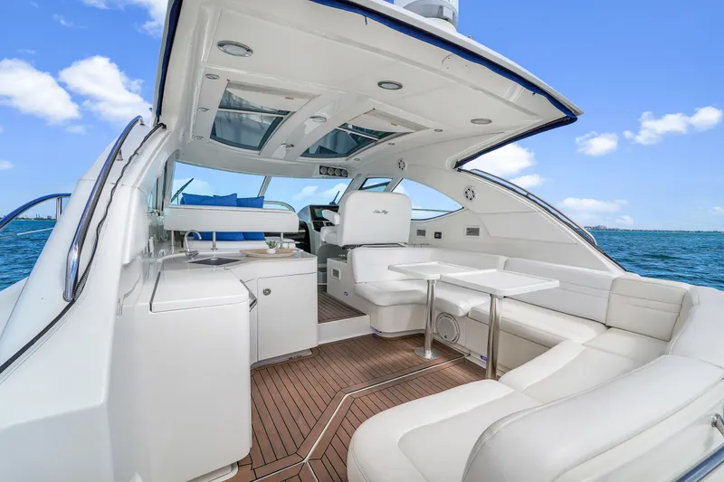 Slide: The Image of 2011 Sea Ray 470 Sundancer yacht interior with white seating and ocean view. - 42