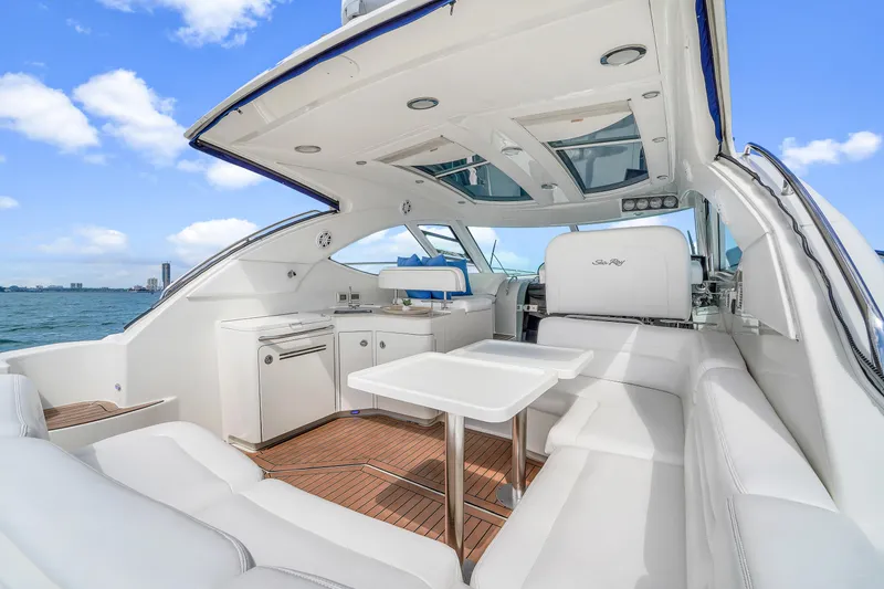 Slide: The Image of 2011 Sea Ray 470 Sundancer yacht interior with white seating and ocean view. - 43