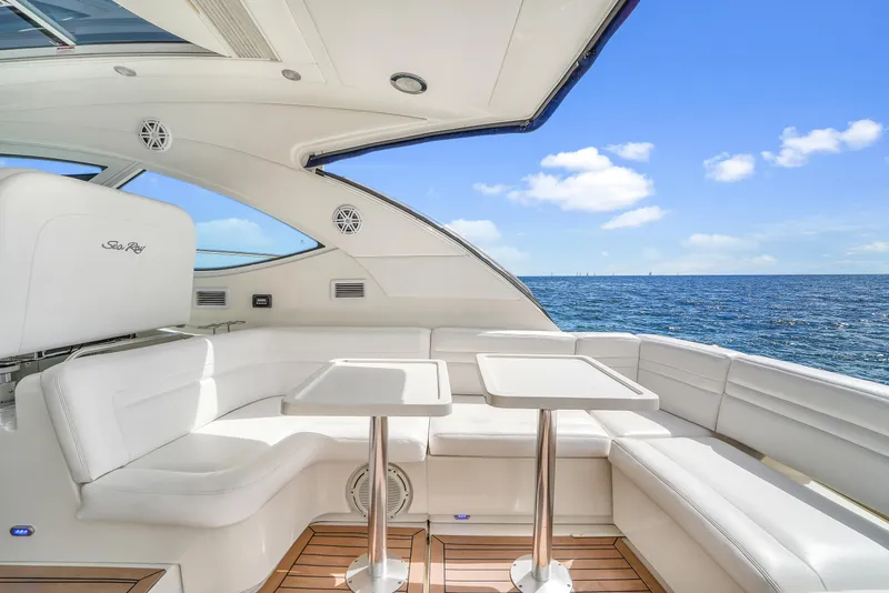 Slide: The Image of Luxurious 2011 Sea Ray 470 Sundancer yacht interior with ocean view and white seating. - 44