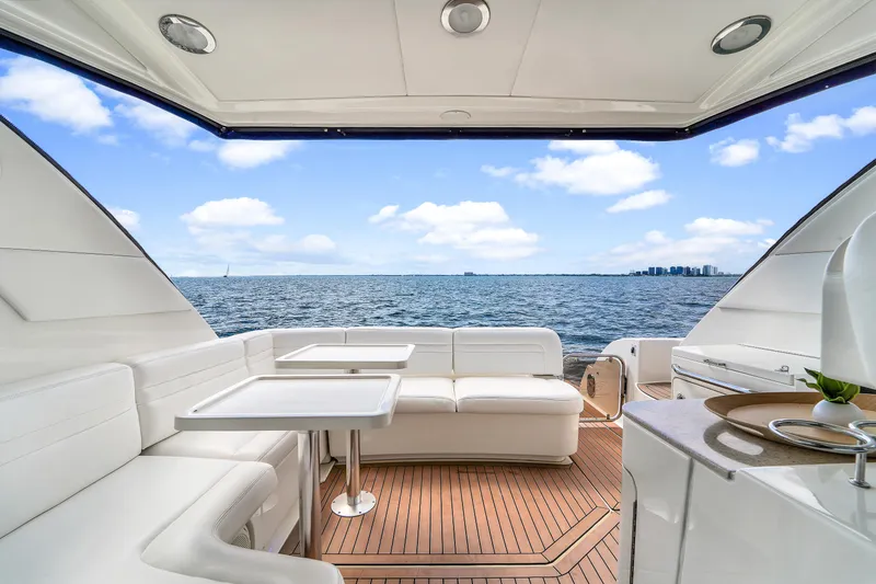 Slide: The Image of Luxurious 2011 Sea Ray 470 Sundancer yacht interior with ocean view and elegant seating. - 45
