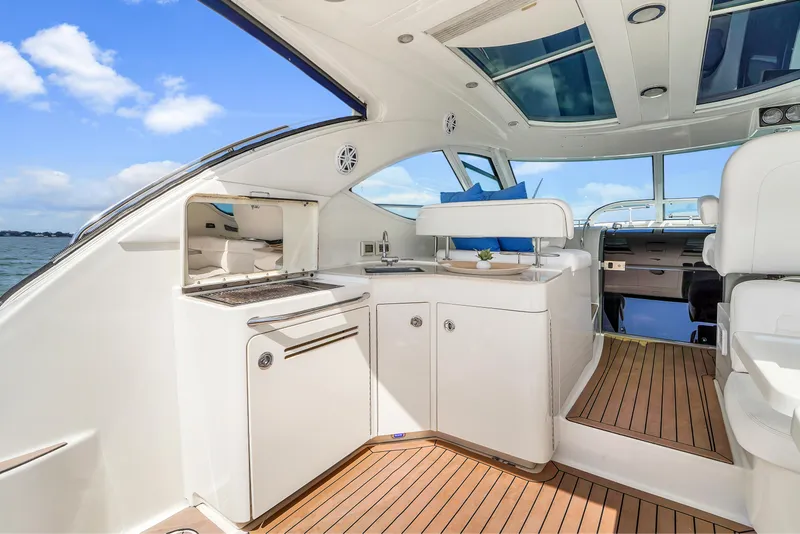 Slide: The Image of Luxurious interior of 2011 Sea Ray 470 Sundancer yacht with modern amenities and wooden flooring. - 48