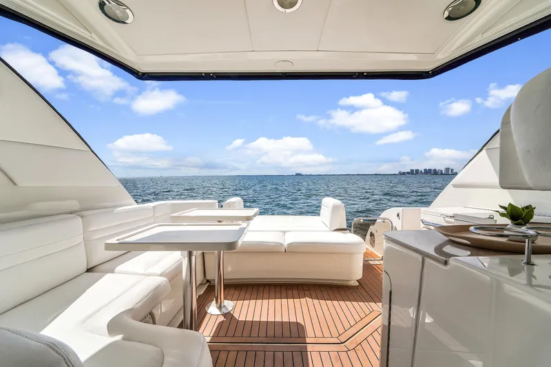 Slide: The Image of Luxurious 2011 Sea Ray 470 Sundancer yacht interior with ocean view and elegant seating. - 49