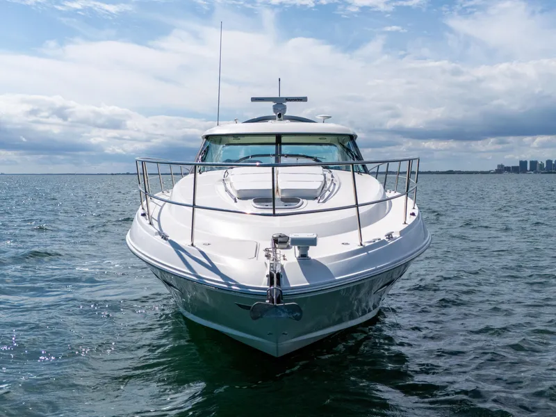 Slide: The Image of 2011 Sea Ray 470 Sundancer yacht on open water under a cloudy sky. - 5