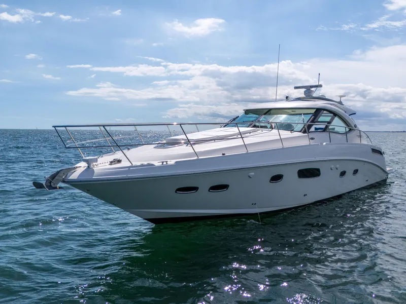 Slide: The Image of 2011 Sea Ray 470 Sundancer yacht cruising on open water under a clear sky. - 6