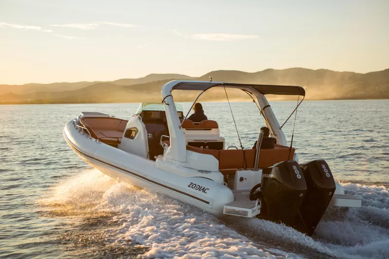 The Image of 2025 Zodiac Medline 9 boat cruising on water at sunset. - 0