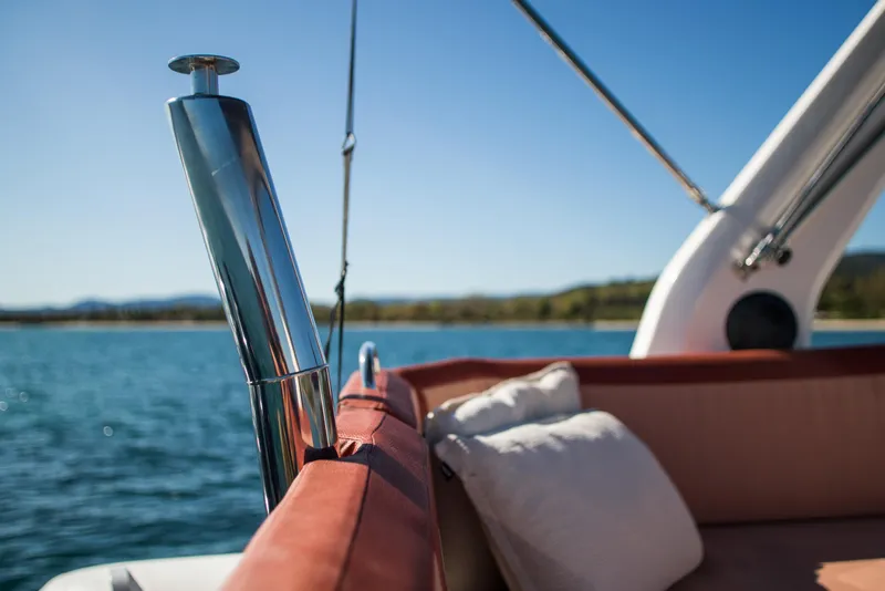 Slide: The Image of 2025 Zodiac Medline 9 boat interior with cushions, overlooking serene water and distant shoreline. - 12