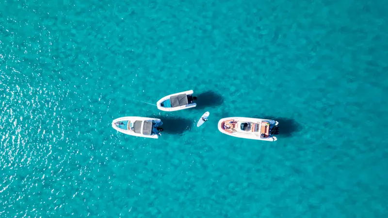 Slide: The Image of Aerial view of Zodiac Medline 9 boats on clear turquoise water, 2025 model. - 13