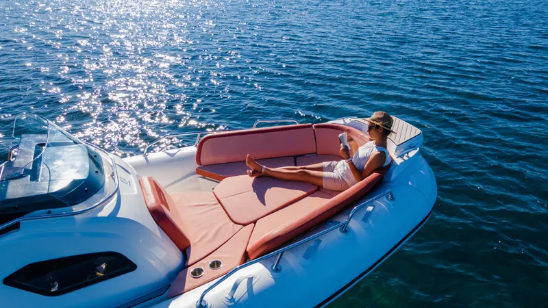 Slide: The Image of Woman relaxing on a 2025 Zodiac Medline 9 boat in sunny waters. - 19
