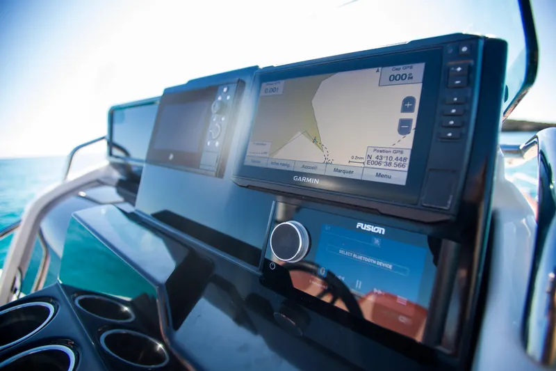 Slide: The Image of 2025 Zodiac Medline 9 dashboard with Garmin navigation system and Fusion audio controls. - 2