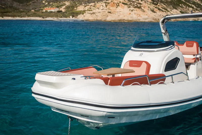 Slide: The Image of 2025 Zodiac Medline 9 boat on clear blue water, coastal background. - 20